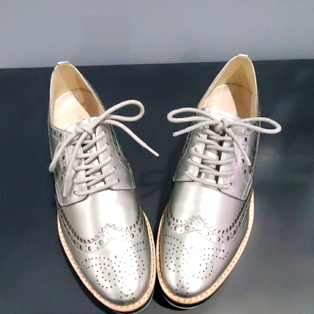 Leather platinum wedge sneaker. Size 8.5 US. Super cute!
